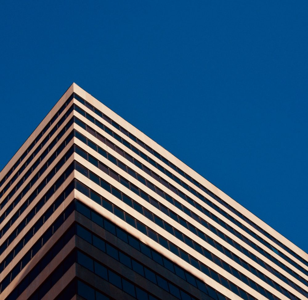 brown and white concrete building under blue sky during daytime